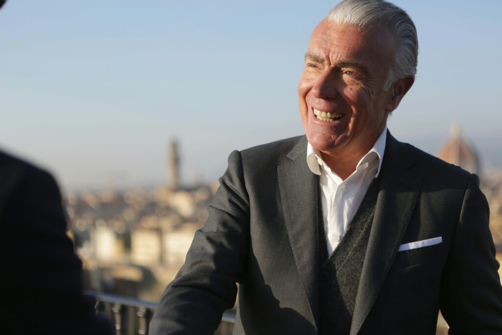 pexels-photo-3783577-3783577 Senior businessman smiling confidently with cityscape in the background, exuding leadership and professionalism.